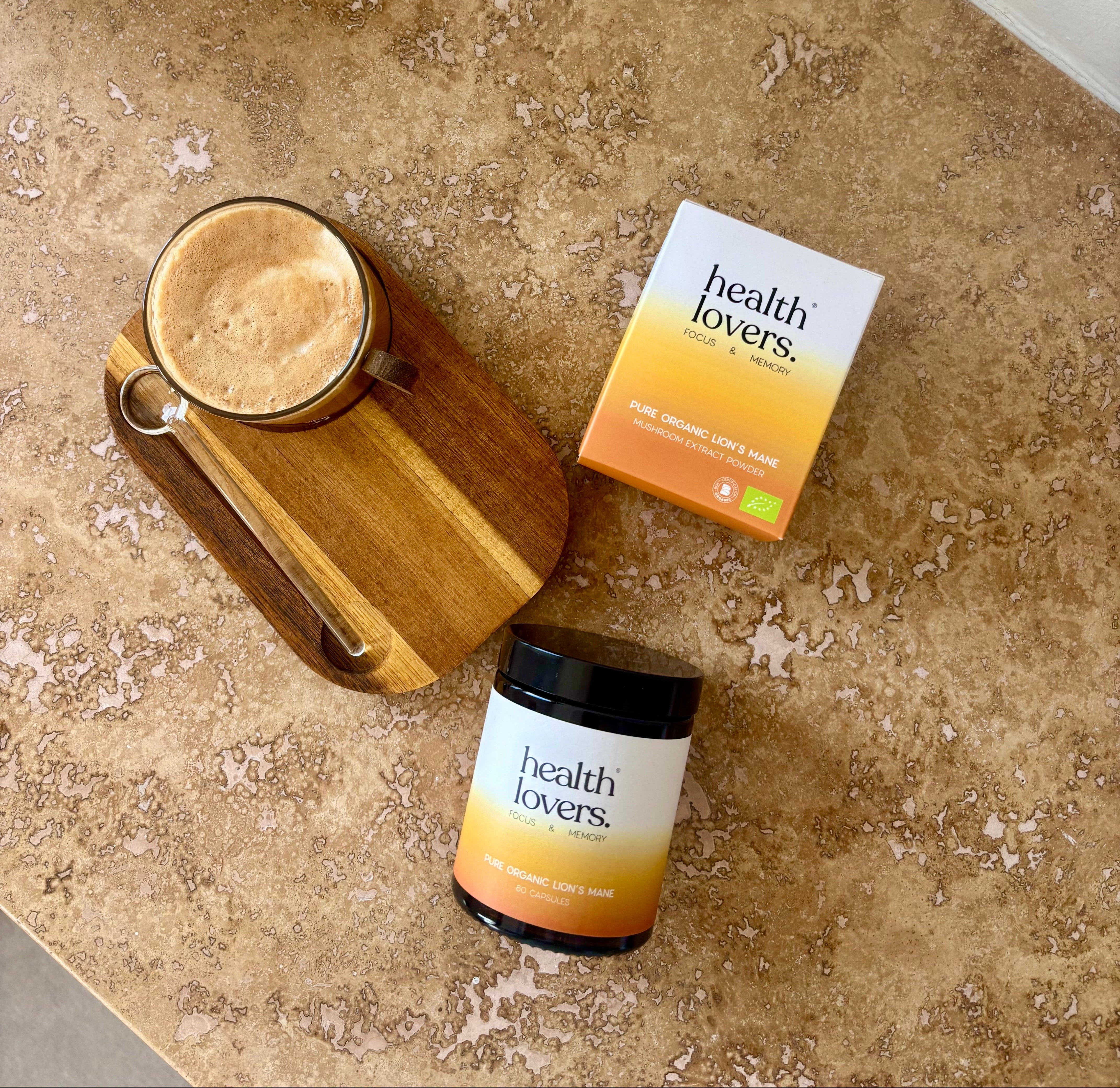 Health Lovers functional mushroom product packaging on a textured surface with a glass of liquid.